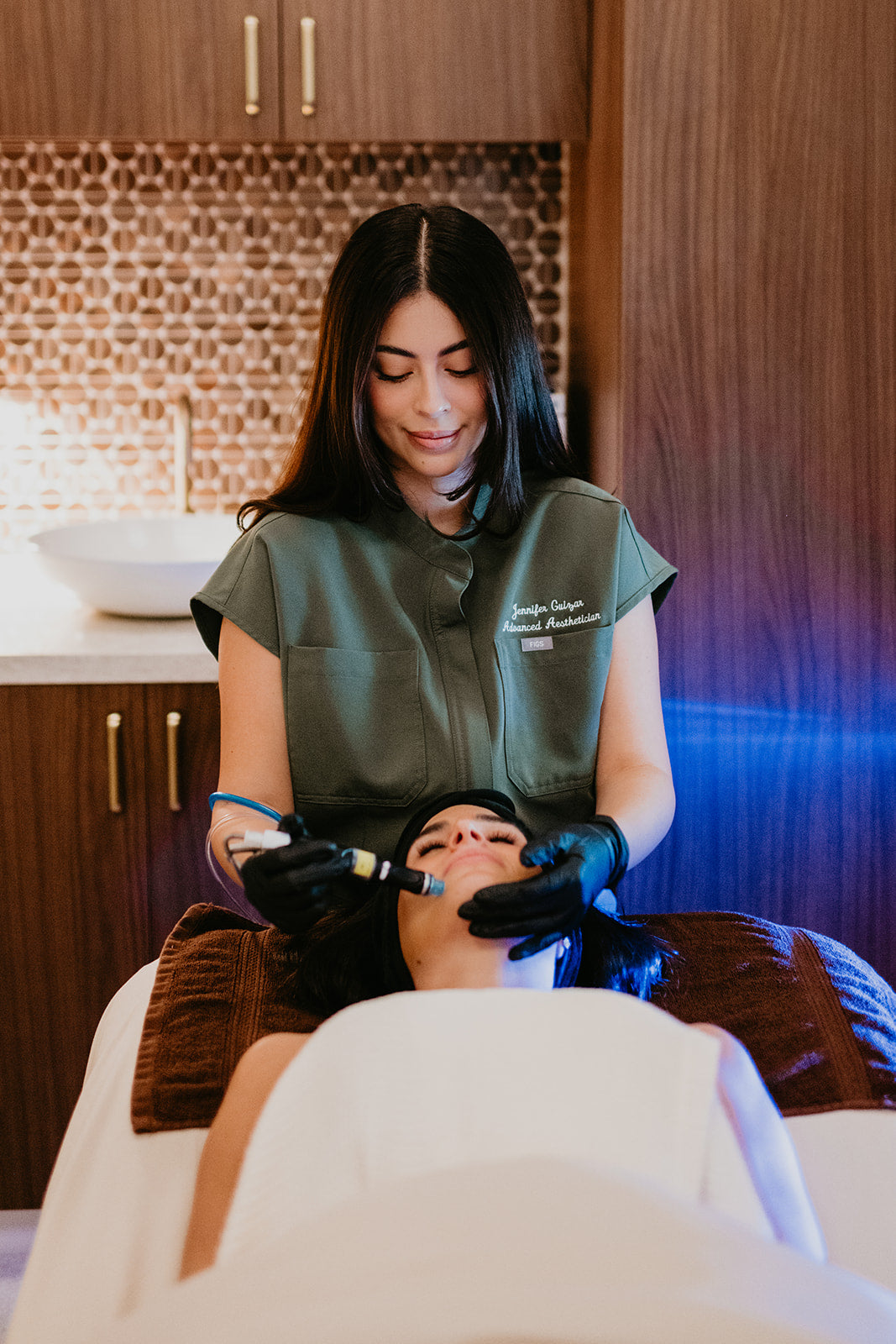 Advanced Aesthetician performing a facial treatment on a client