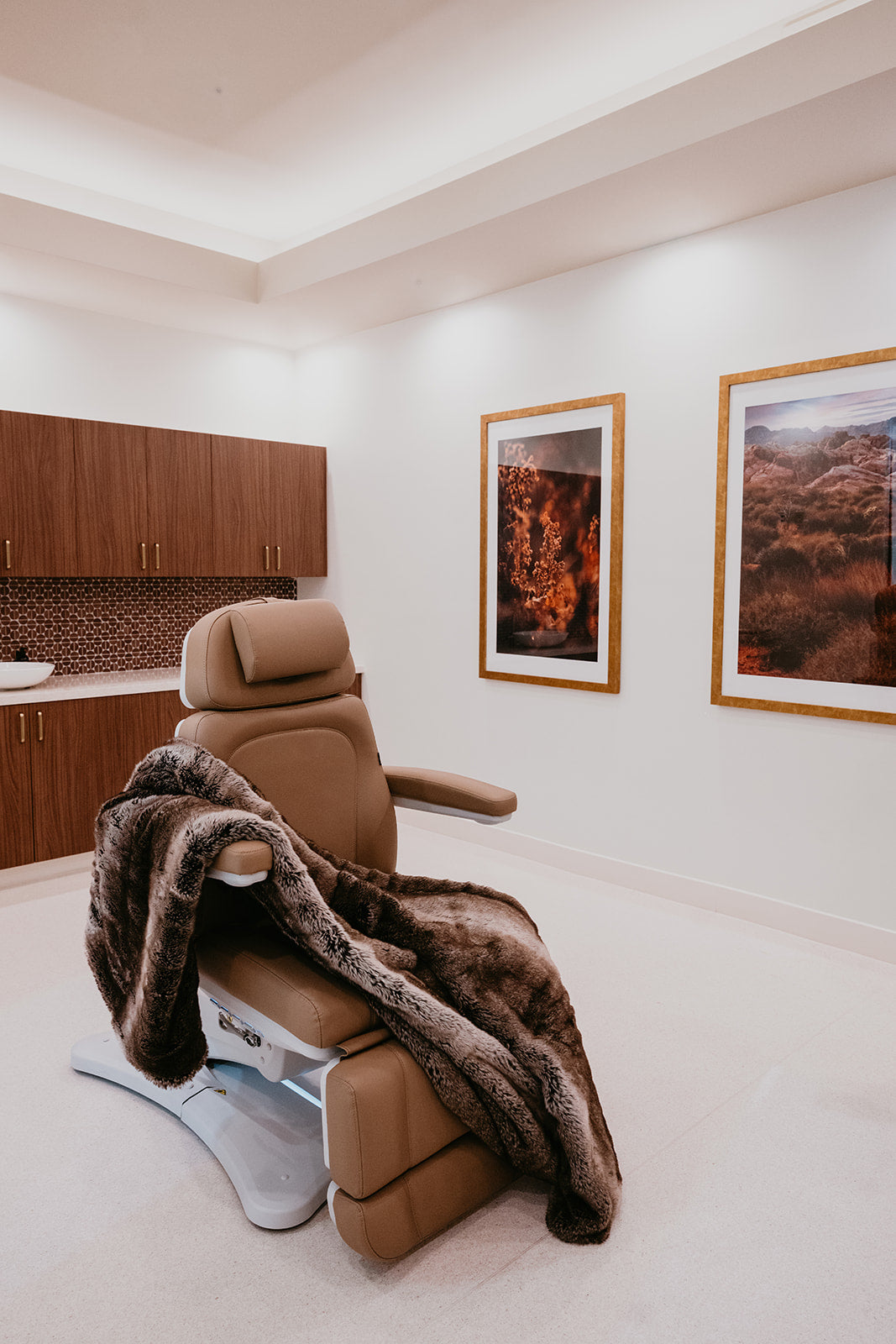 Luxury medical spa treatment room with tan chair and faux fur blanket